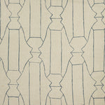 Woven fabric swatch in a repeating curvolinear print in navy on a tan field.