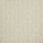 Woven fabric swatch in a repeating curvolinear print in white on a cream field.