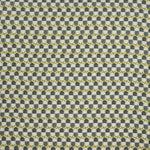 Woven fabric swatch in a repeating mosaic print in shades of green and gray-blue on a tan field.