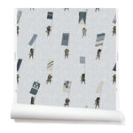 A roll of wallpaper with a pattern of hand-drawn Japanese soldiers carrying various geometric flags, on a light gray background.
