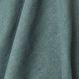 A draped swatch of old-world linen fabric in a solid dark green color.