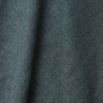 A draped swatch of old-world linen fabric in a solid dark green-gray color.