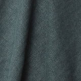 A draped swatch of old-world linen fabric in a solid dark green-gray color.