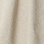 A draped swatch of old-world linen fabric in a solid cream color.