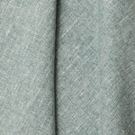 A draped swatch of blended linen fabric in a mottled light jade color.