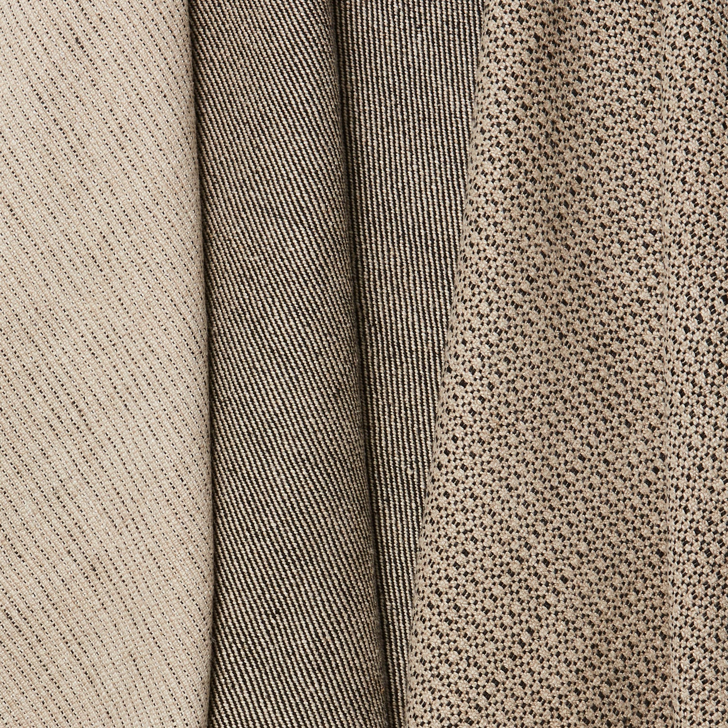 Group of three folded linen swatches in three different small-scale patterns, all in shades of tan and black.