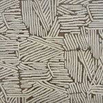 Detail of rug with an abstract woodcut inpsired pattern in grey and cream