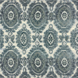 Detail of a handknotted rug with a floral medallion pattern in shades of acqua and grey. 