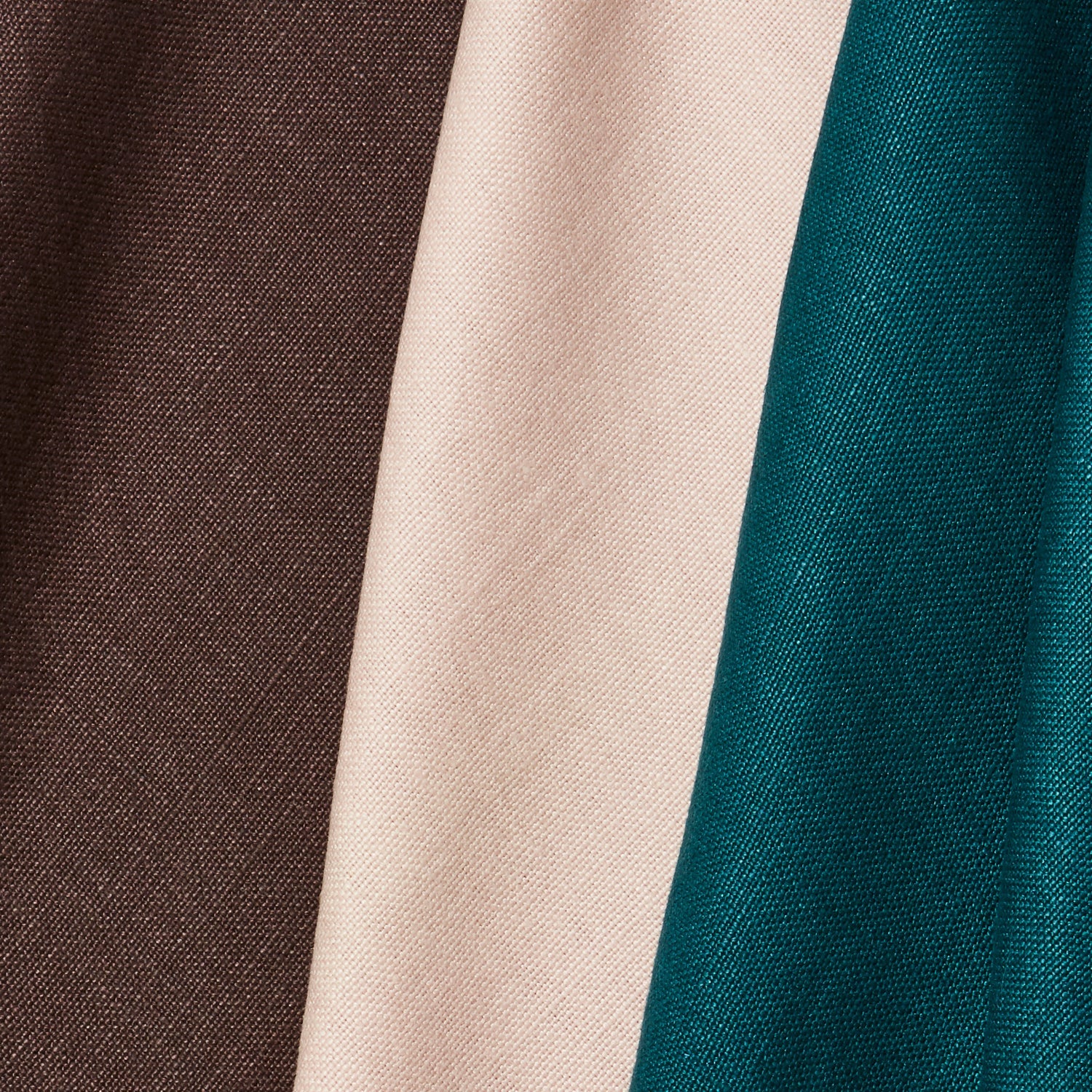 A group of three folded pieces of linen fabric in shades of espresso, turquoise and pale pink.