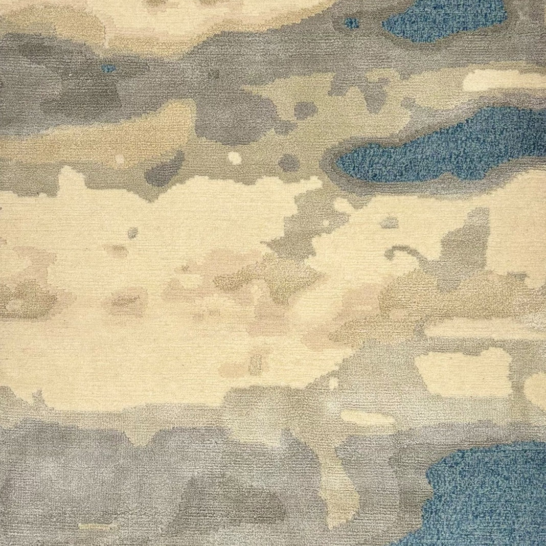 Detail of a woolblend rug in tan, cream and acqua in an abstract textural pattern.