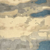 Detail of a woolblend rug in tan, cream and acqua in an abstract textural pattern.