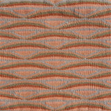 Detail of handwoven rug in a wavy striped pattern in shades of orange