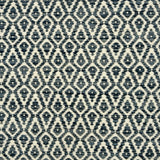 Detail of a handowven rug in an diamond like pattern in white and shades of blue.