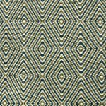 Detail of a flatwoven rug with a diamond pattern in white, blue and green.