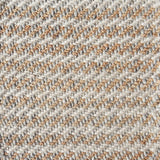 Detail of a textural rug in natural fiber and grey and white yarn.