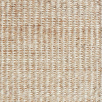 Detail of a textural rug in natural fiber and cream yarn.