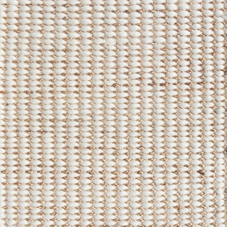Detail of a textural rug in natural fiber and white yarn.