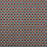 Swatch of fabric with a repeating Japanese-inspired scalloped pattern in shades of navy, blue and red. 