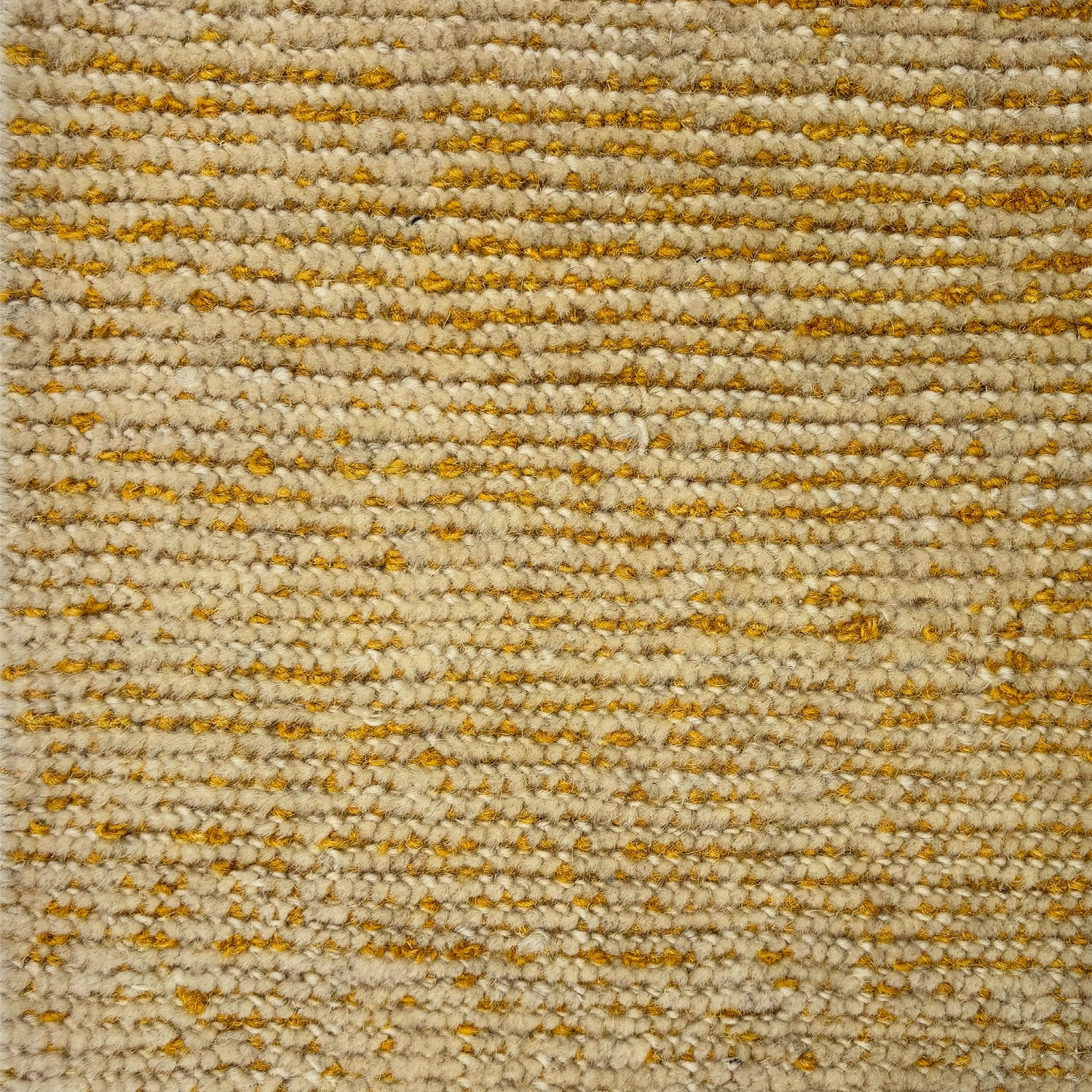 Detail of a wool rug in a textural weave in yellow