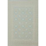 Patterned rug with geometric design on a light gray background