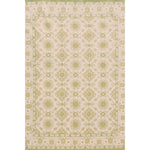Handmade rug with with ornate green and cream design.