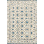 Decorative rug with geometric pattern in grey and blue on a white background