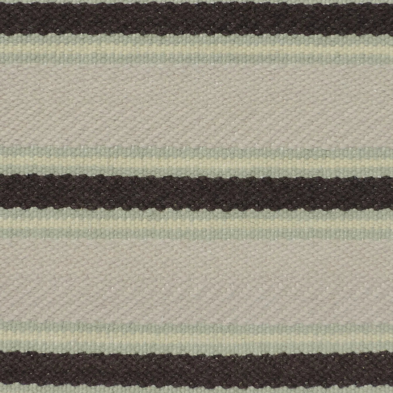 Handmade rug with stripes in mint green, cream and brown.