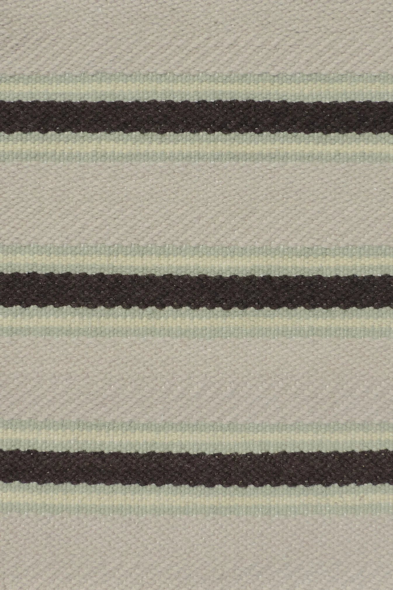 Handmade rug with stripes in mint green, cream and brown.