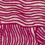 Close-up of carpet with wavy magenta lines on a beige background