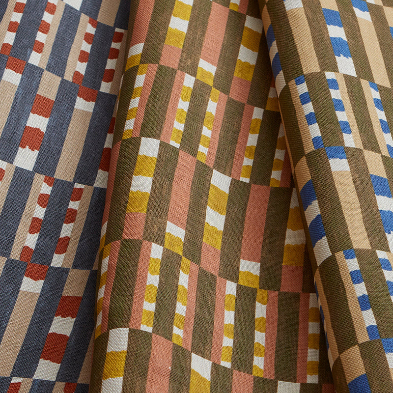 Stack of three folded swatches in a tiled stripe pattern in Carnelian, Jonquil and Cobalt