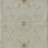 Close up of hand woven rug in a floral filigree pattern in grey, tan and cream on a pastel aqua blue field.
