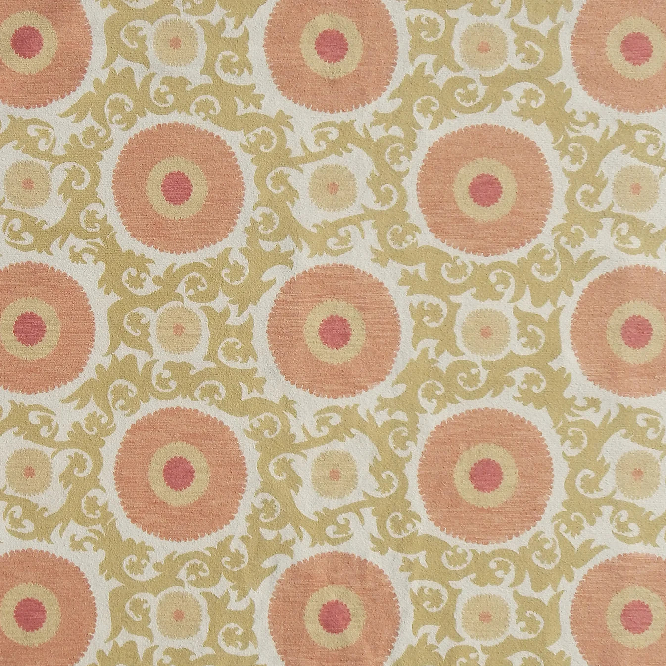 Handmade rug with floral and scroll designs in pink and green on a light background