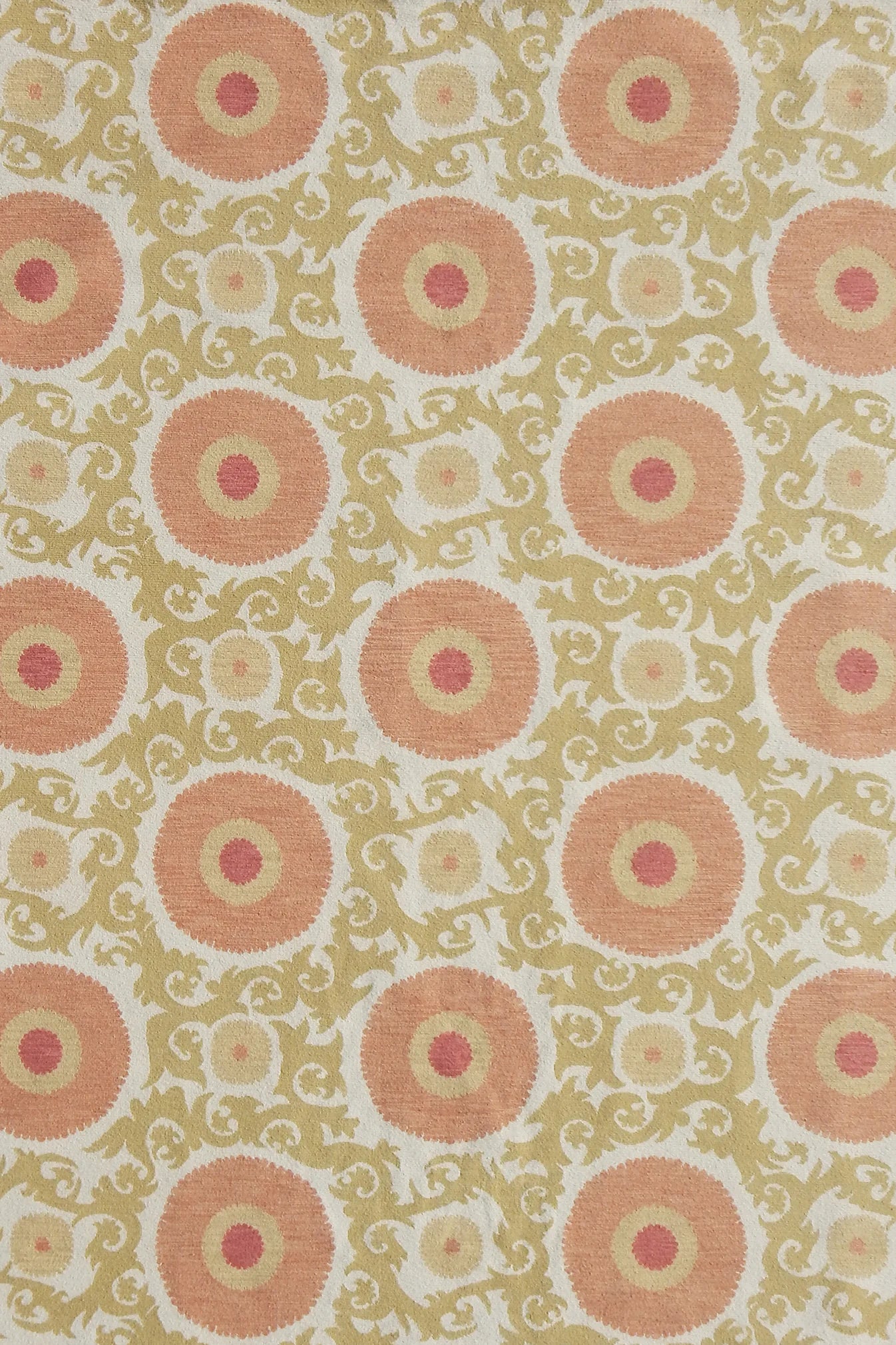 Handmade rug with floral and scroll designs in pink and green on a light background