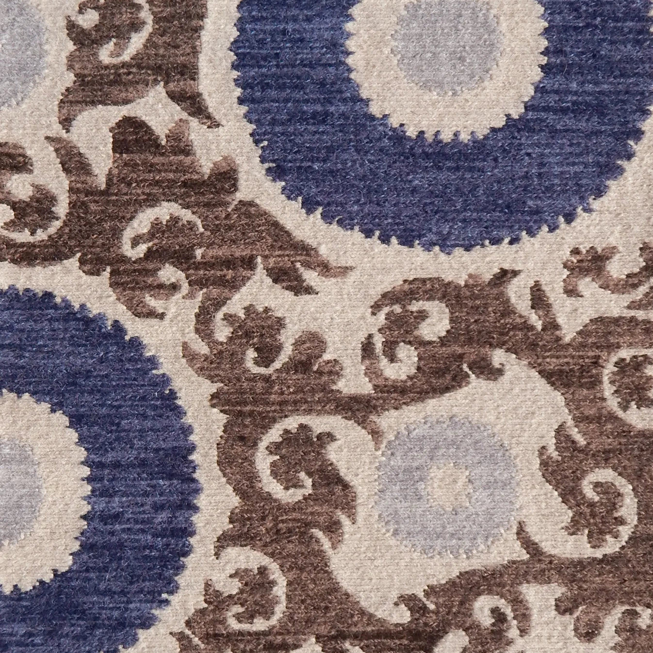 Decorative rug with floral scroll pattern pattern in blue and brown on a beige background