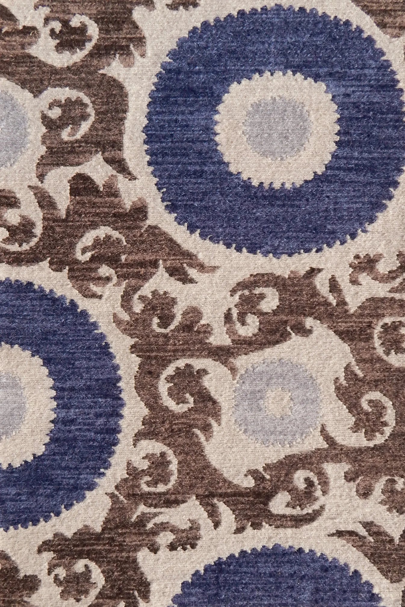 Decorative rug with floral scroll pattern pattern in blue and brown on a beige background