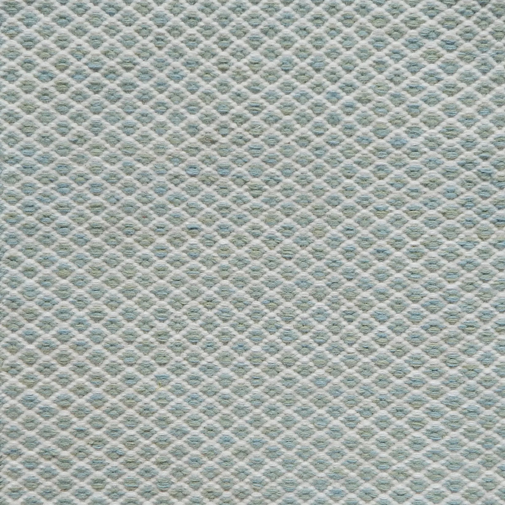 Flatweave rug with small scale lattice in white with aqua blue field. 