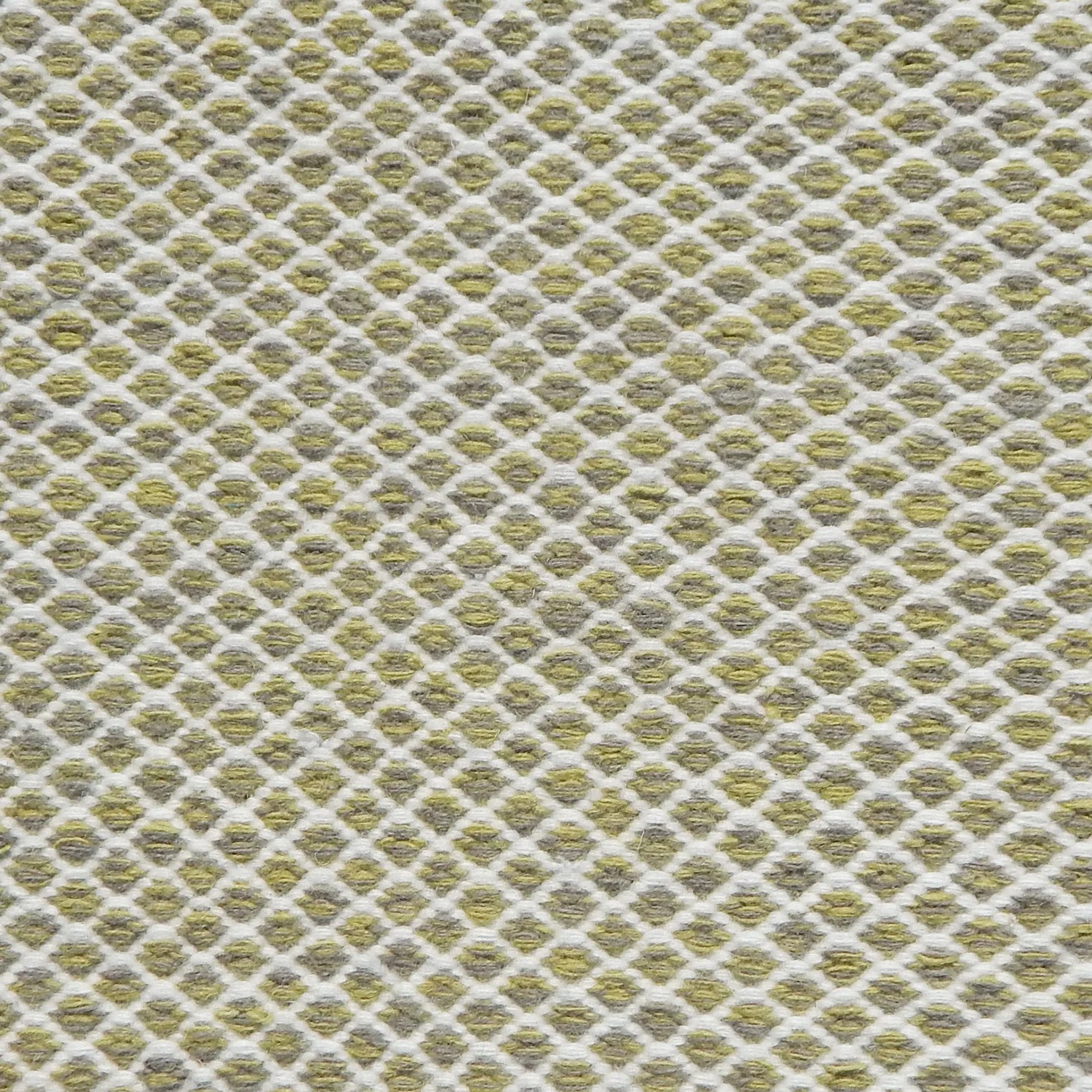 Flatweave rug with small scale lattice in white with lime green field. 