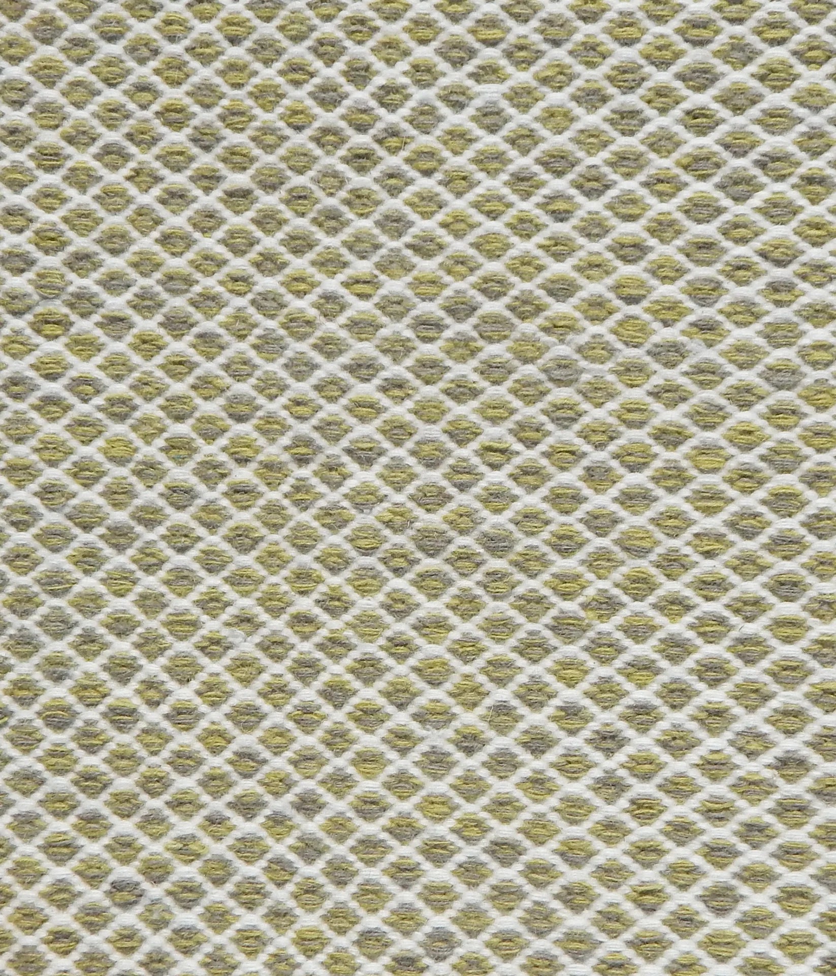Flatweave rug with small scale lattice in white with lime green field. 