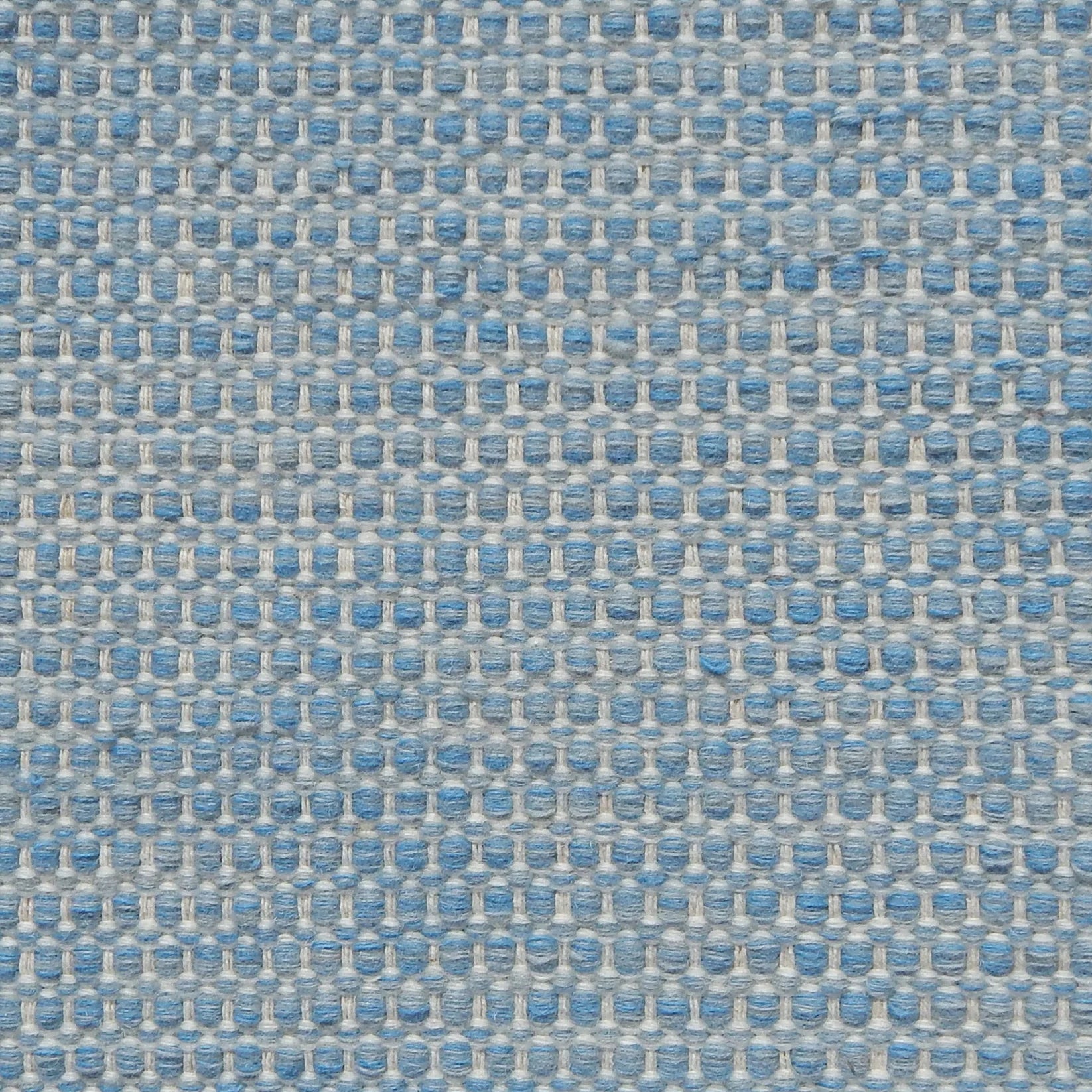 Textured handwoven carpet in light blue