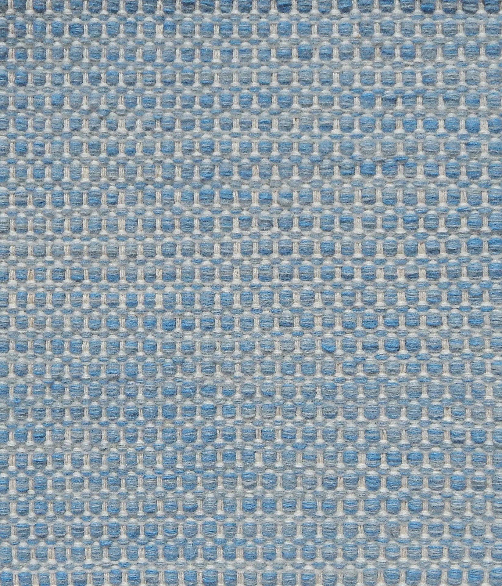 Textured handwoven carpet in light blue