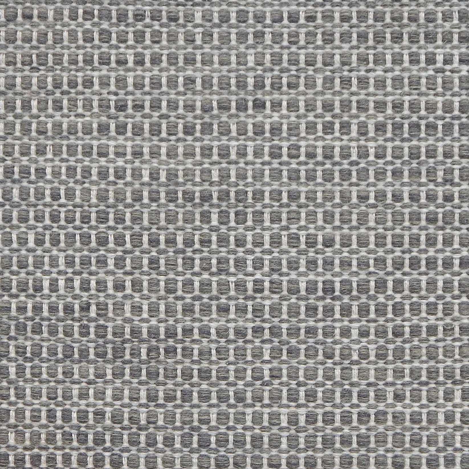 Textured handwoven carpet in charcoal grey