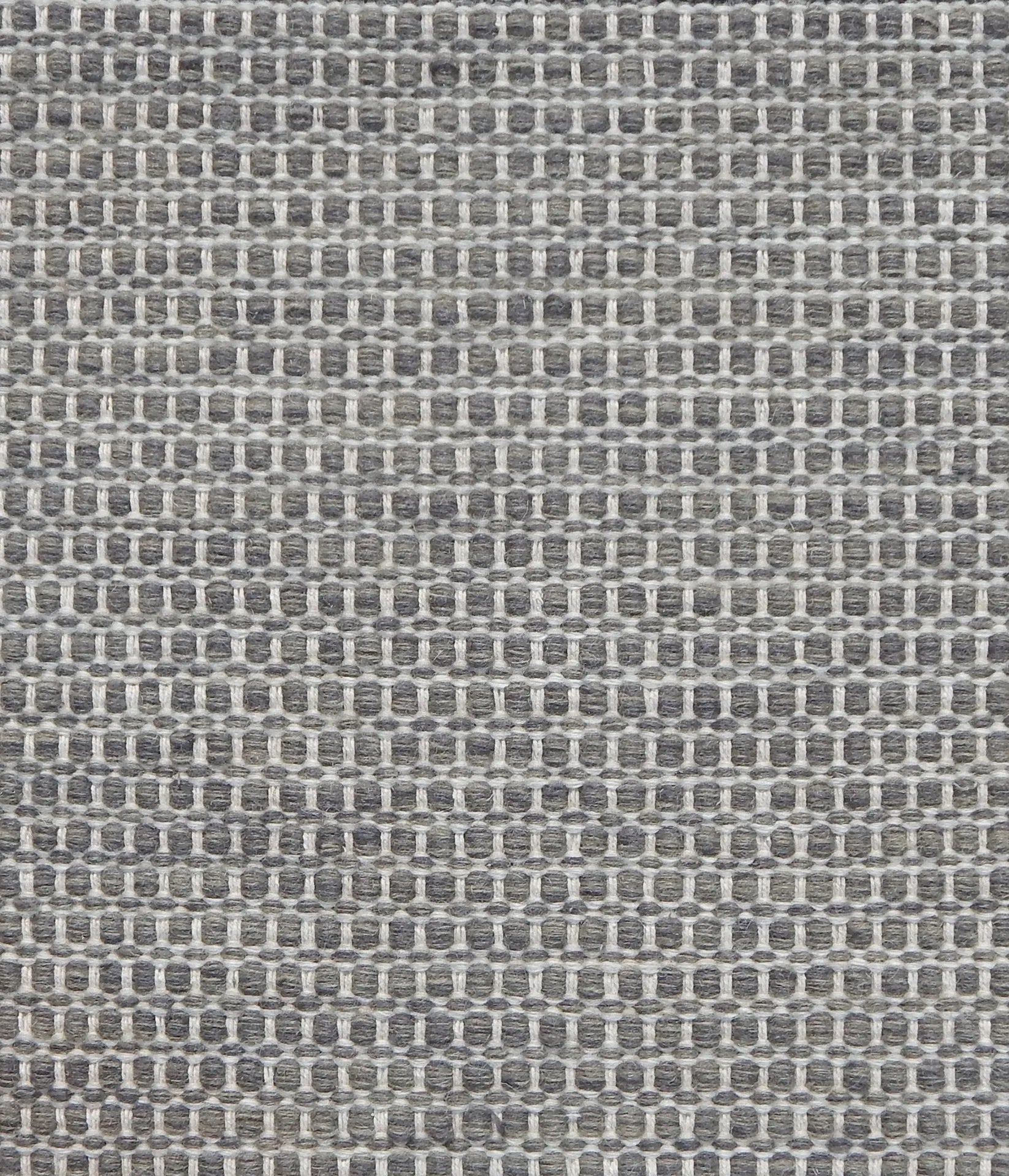 Textured handwoven carpet in charcoal grey