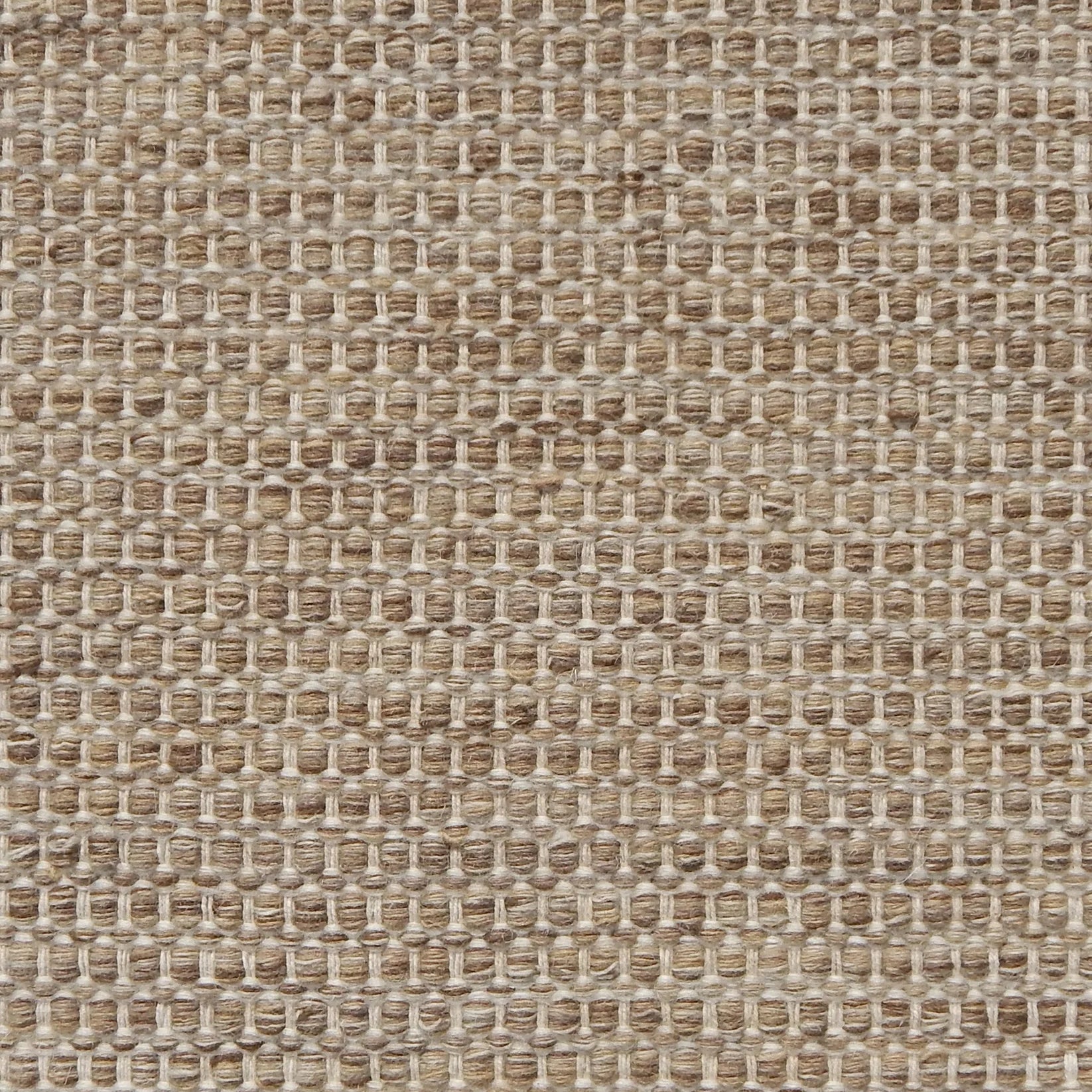 Textured handwoven carpet in light brown.