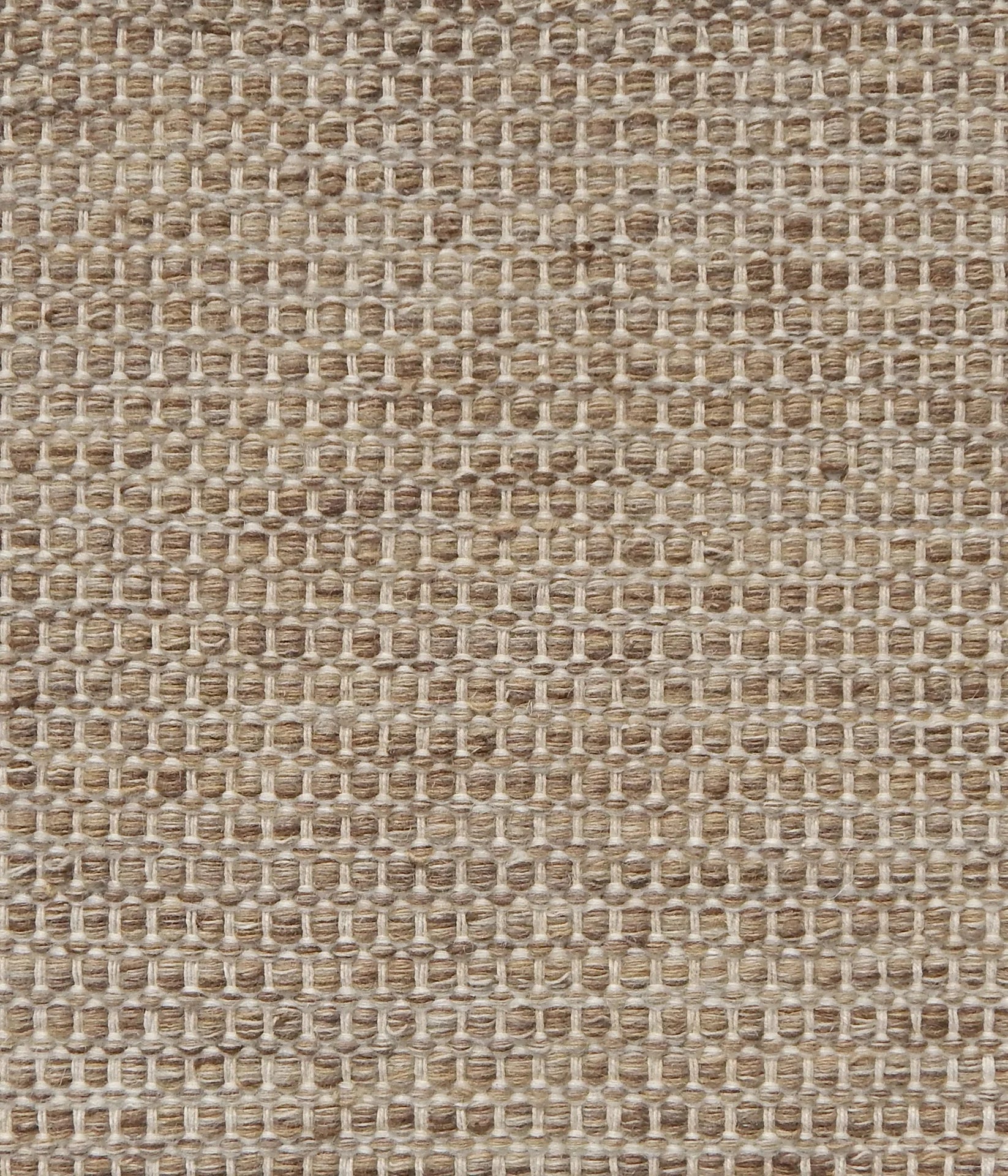 Textured handwoven carpet in light brown.