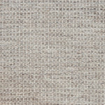 Textured handwoven carpet in light grey.