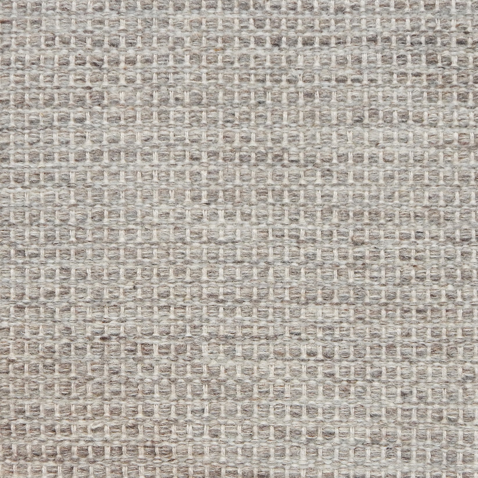 Textured handwoven carpet in light grey.