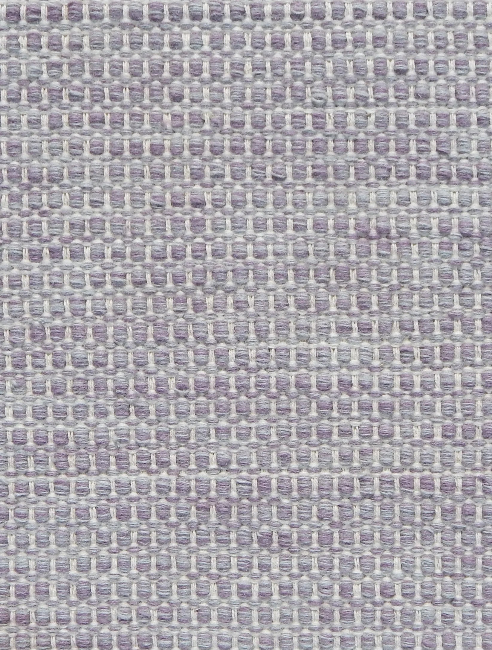Textured handwoven carpet in pale purple 