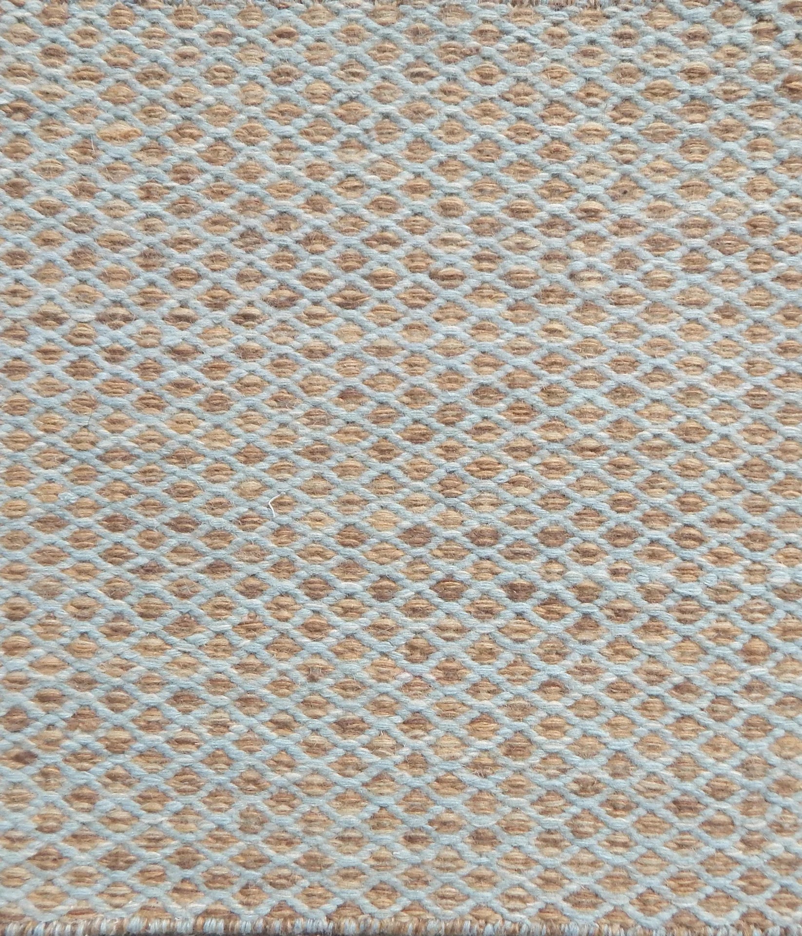 Flatweave rug with small scale lattice in light blue with tan field. 