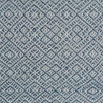 Flatweave rug with an intricate diamond pattern in white and teal