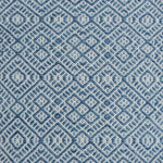 Flatweave rug with an intricate diamond pattern in white and blue